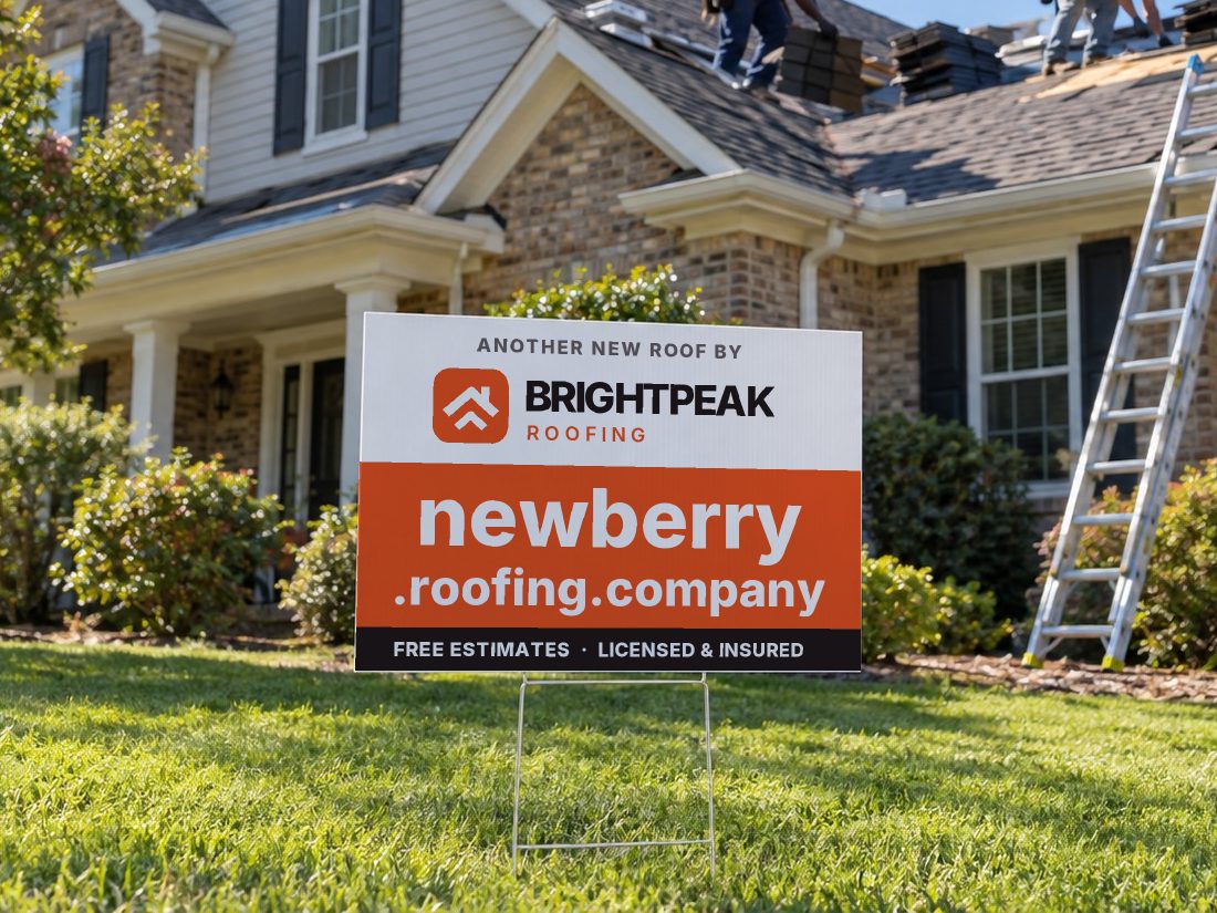 newberry.roofing.company on a yard sign in front of a house getting a new roof